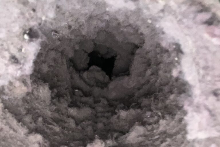 Dryer vent duct clogged with lint before cleaning