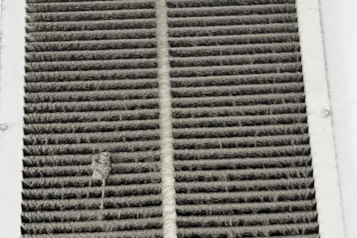 Dust-clogged return air grille before air duct cleaning in Tampa Bay