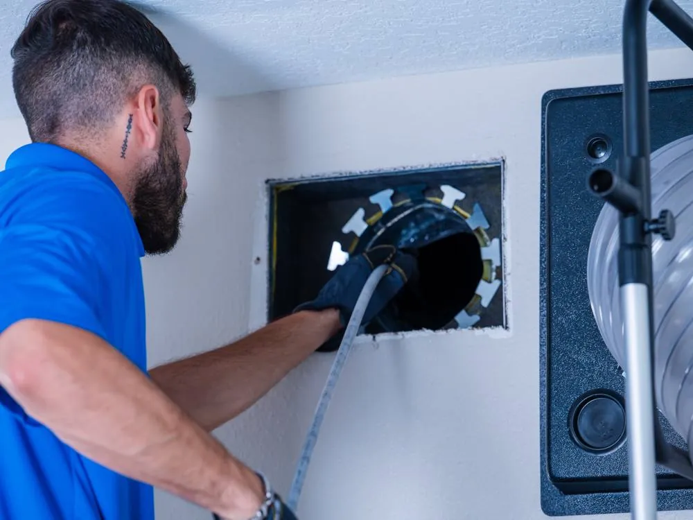 Technician cleaning a dryer vent in Tampa